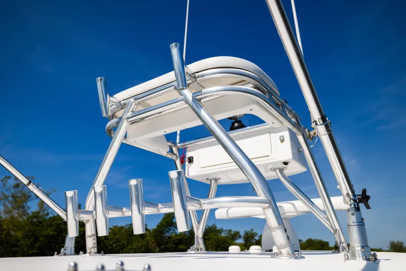 Slide: The Image of 2015 Invincible 39 Open Fisherman boat with stainless steel rod holders against blue sky. - 37