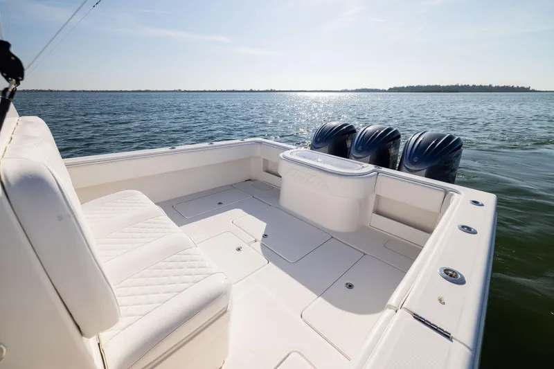 Slide: The Image of 2015 Invincible 39 Open Fisherman boat with triple engines on calm water. - 39
