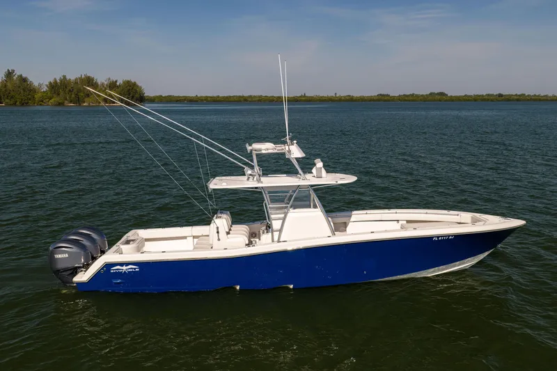 Slide: The Image of 2015 Invincible 39 Open Fisherman boat on calm water, featuring dual Yamaha engines. - 4