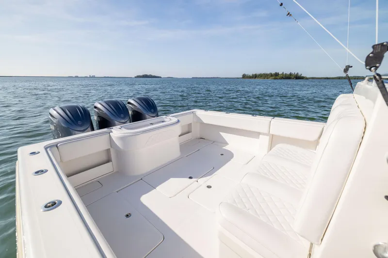 Slide: The Image of 2015 Invincible 39 Open Fisherman boat with triple engines on calm water. - 40