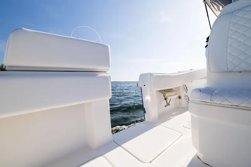 Slide: The Image of 2015 Invincible 39 Open Fisherman boat interior with white seating, ocean view. - 41
