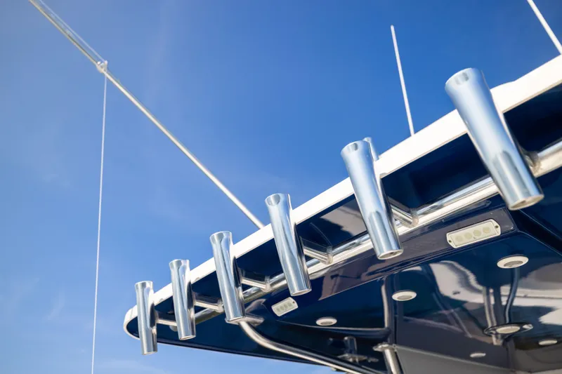 Slide: The Image of Rod holders on a 2015 Invincible 39 Open Fisherman boat against a clear blue sky. - 45