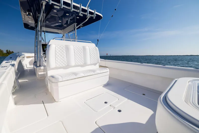 Slide: The Image of 2015 Invincible 39 Open Fisherman boat with white seating, on calm waters under clear blue sky. - 46