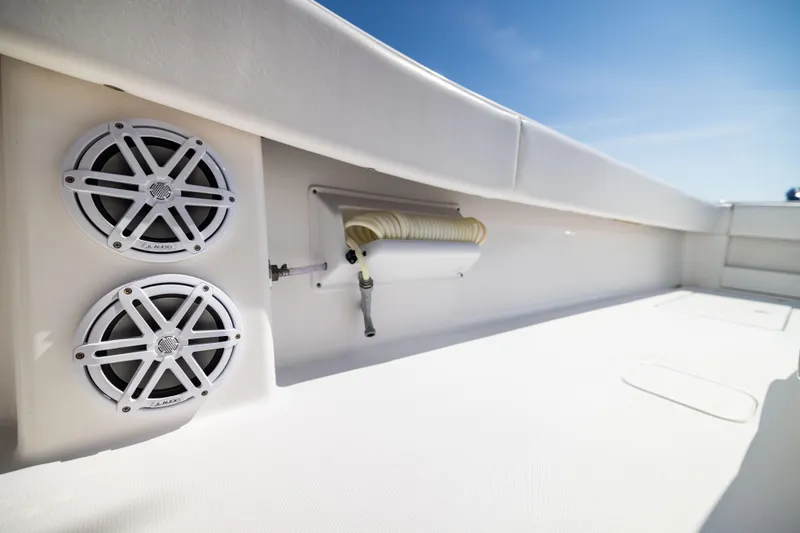Slide: The Image of 2015 Invincible 39 Open Fisherman boat deck with speakers and hose storage. - 49
