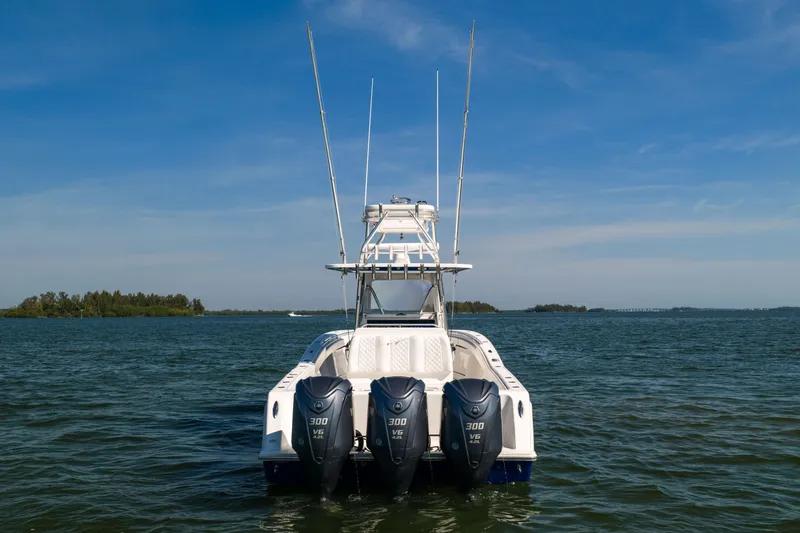 Slide: The Image of 2015 Invincible 39 Open Fisherman boat with triple 300 V6 engines on open water. - 5