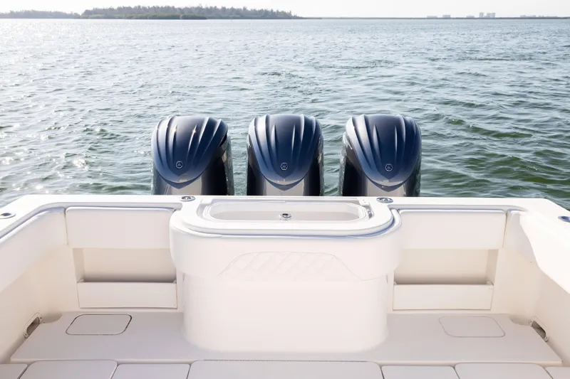 Slide: The Image of 2015 Invincible 39 Open Fisherman boat with triple outboard engines on calm water. - 50