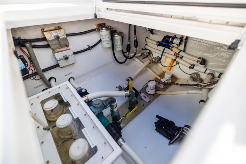 Slide: The Image of Engine compartment of a 2015 Invincible 39 Open Fisherman boat, showcasing wiring and plumbing. - 54