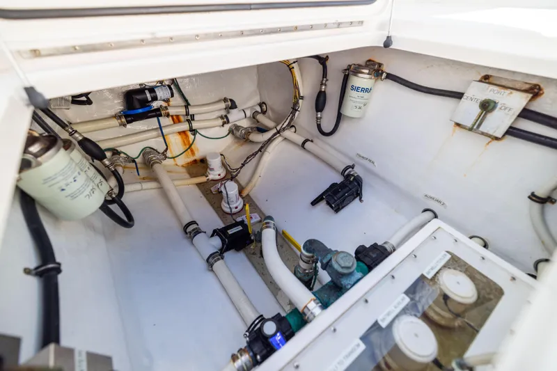 Slide: The Image of Engine compartment of 2015 Invincible 39 Open Fisherman with visible fuel filters and hoses. - 56