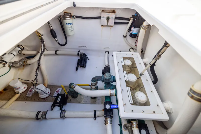Slide: The Image of 2015 Invincible 39 Open Fisherman boat plumbing system with filters and hoses. - 57