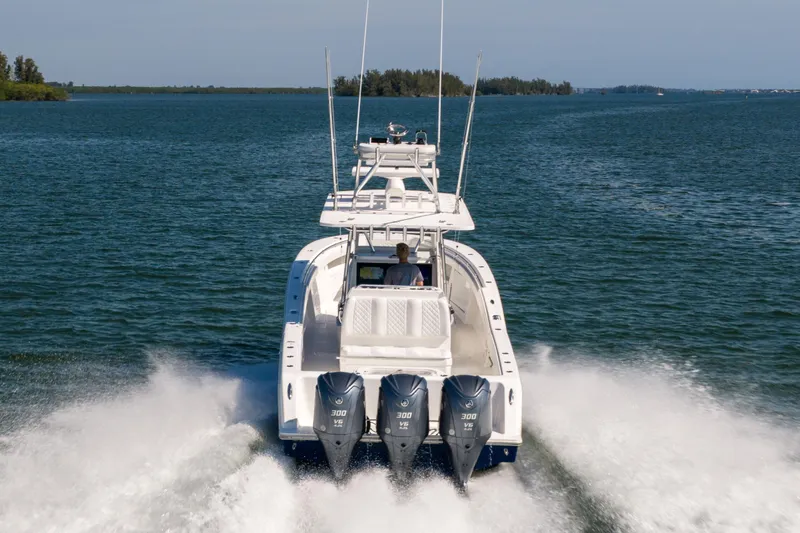 Slide: The Image of 2015 Invincible 39 Open Fisherman speeding on open water with triple engines. - 58