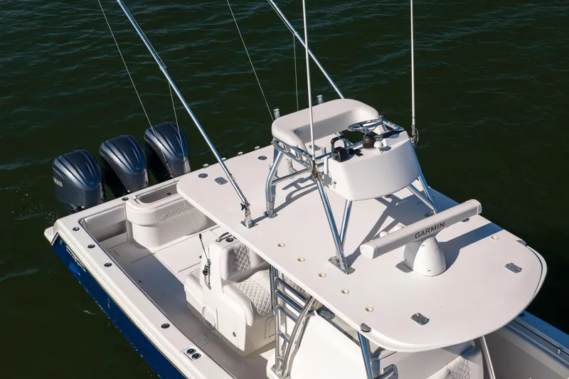 Slide: The Image of 2015 Invincible 39 Open Fisherman boat with triple Yamaha engines on water. - 6