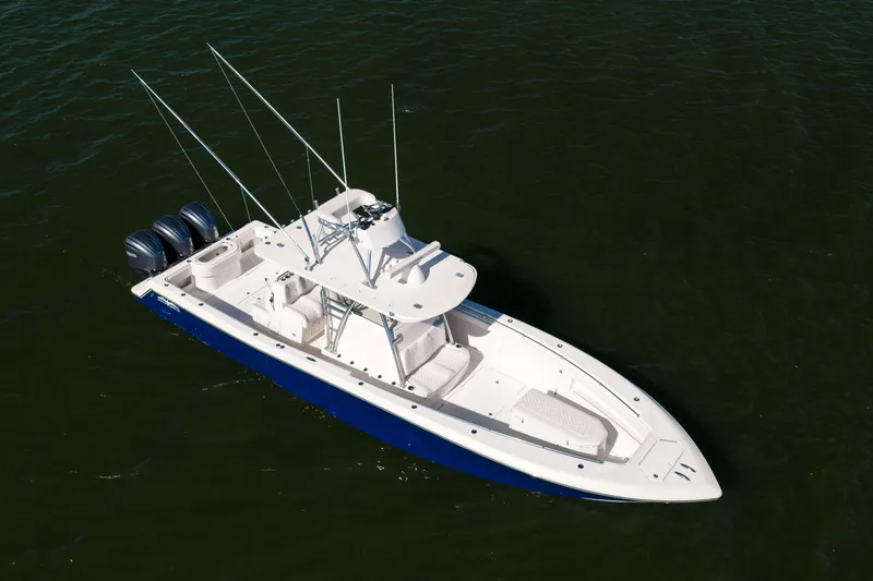 Slide: The Image of 2015 Invincible 39 Open Fisherman boat on water, featuring triple outboard engines. - 7