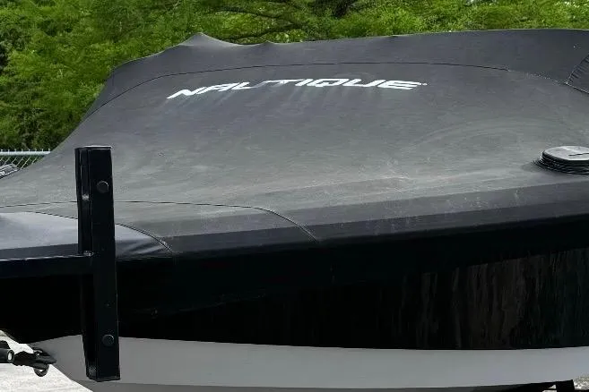 Slide: The Image of 2015 Nautique Ski Nautique 200 Open Bow boat with cover, outdoors. - 8