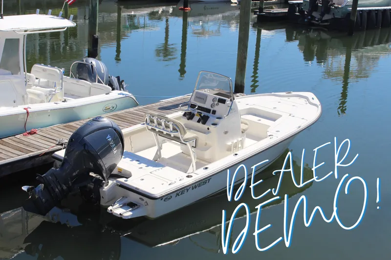 The Image of 2026 Key West 210 Bay Reef boat docked, labeled "Dealer Demo" in marina setting. - 0