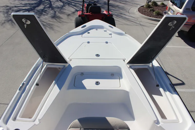 Slide: The Image of 2026 Key West 210 Bay Reef boat with open storage compartments on deck. - 15