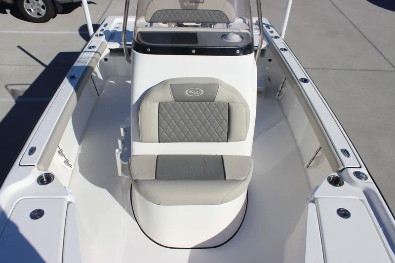Slide: The Image of 2026 Key West 210 Bay Reef boat interior with cushioned seating and console. - 18