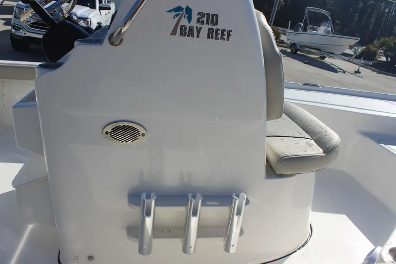 Slide: The Image of 2026 Key West 210 Bay Reef boat interior with seating and rod holders. - 9