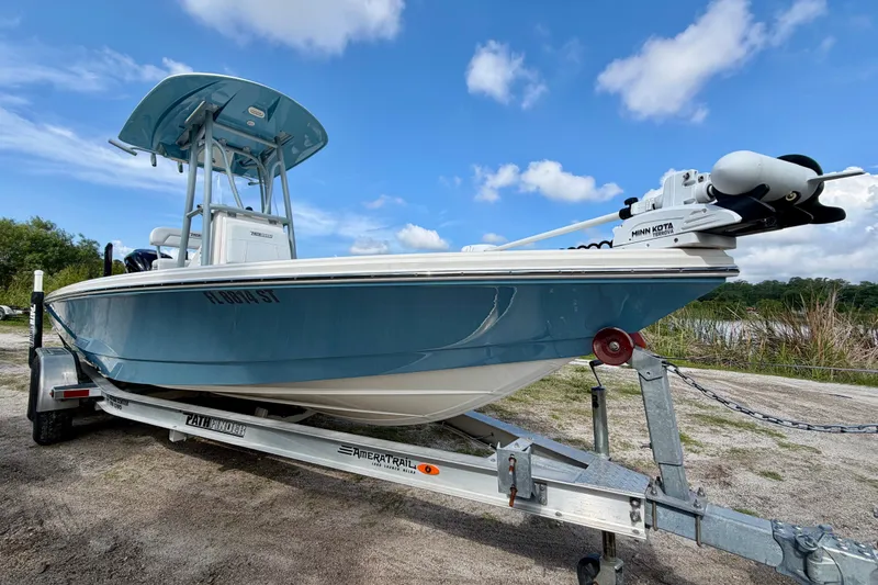 The Image of 2020 Pathfinder 2300 HPS boat on trailer under blue sky. - 1