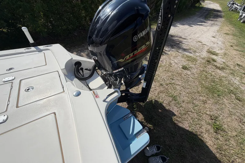 Slide: The Image of 2020 Pathfinder 2300 HPS boat with Yamaha outboard motor on grassy terrain. - 12