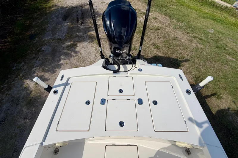 Slide: The Image of 2020 Pathfinder 2300 HPS boat deck with storage compartments and motor, viewed from above. - 15