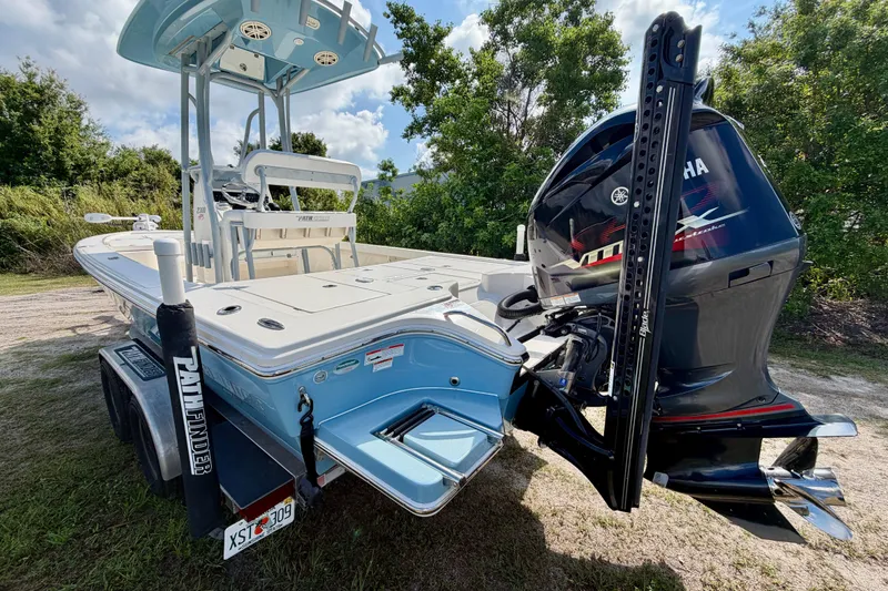 Slide: The Image of 2020 Pathfinder 2300 HPS boat with Yamaha engine on trailer, parked outdoors. - 6