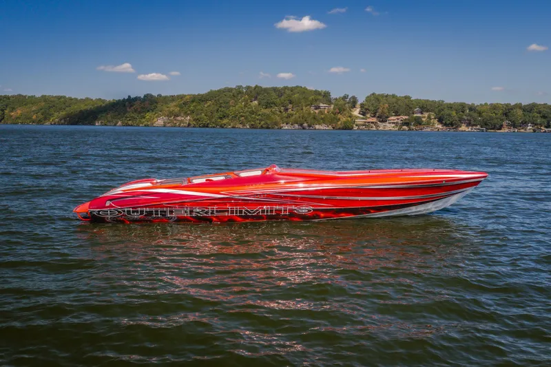 The Image of 2004 Outerlimits 42 Legacy speedboat on a lake with scenic background. - 2