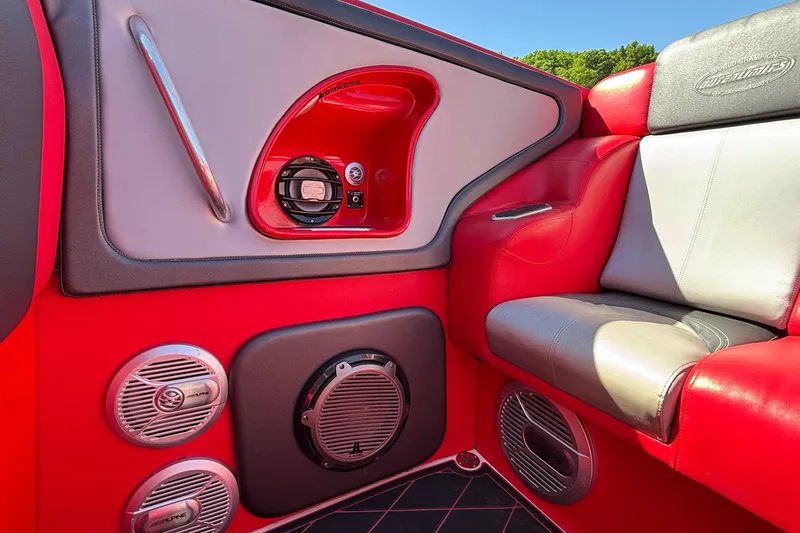 Slide: The Image of Red and gray interior of a 2004 Outerlimits 42 Legacy boat with audio speakers. - 12