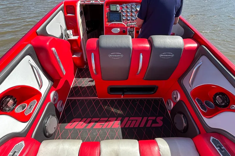 Slide: The Image of Interior of a 2004 Outerlimits 42 Legacy boat with red and gray seating. - 15