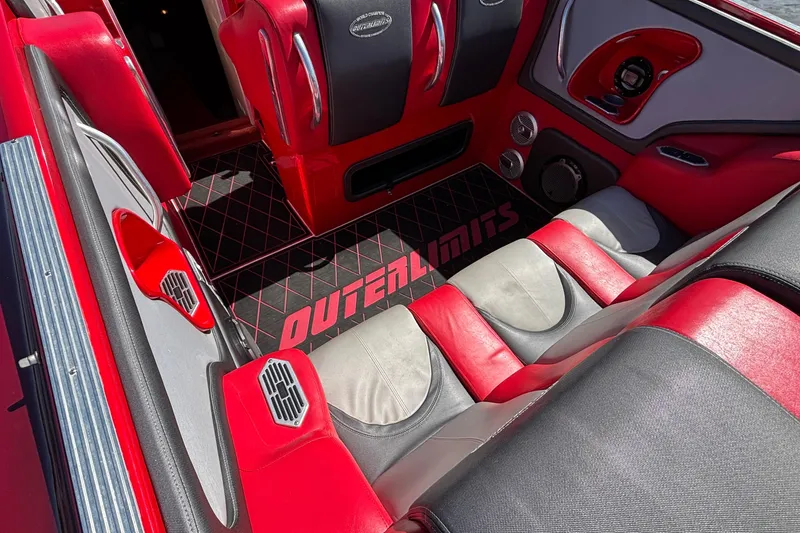 Slide: The Image of Red and gray interior of 2004 Outerlimits 42 Legacy boat, featuring stylish seating and branded floor mat. - 17
