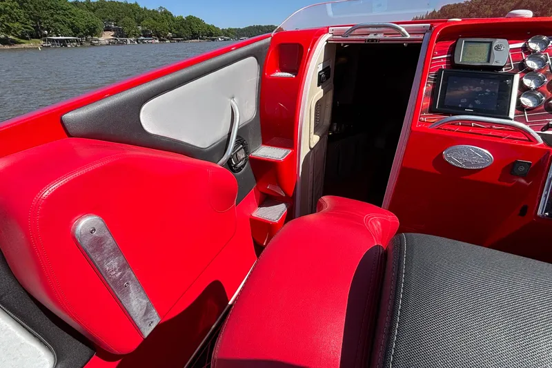 Slide: The Image of Interior of a 2004 Outerlimits 42 Legacy boat with red and black seating. - 18