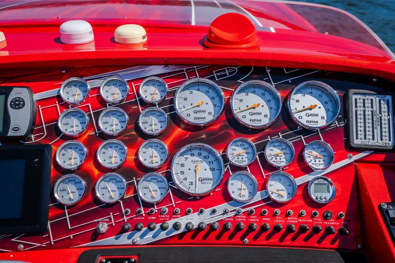 Slide: The Image of Dashboard of a 2004 Outerlimits 42 Legacy boat with multiple gauges and controls. - 26