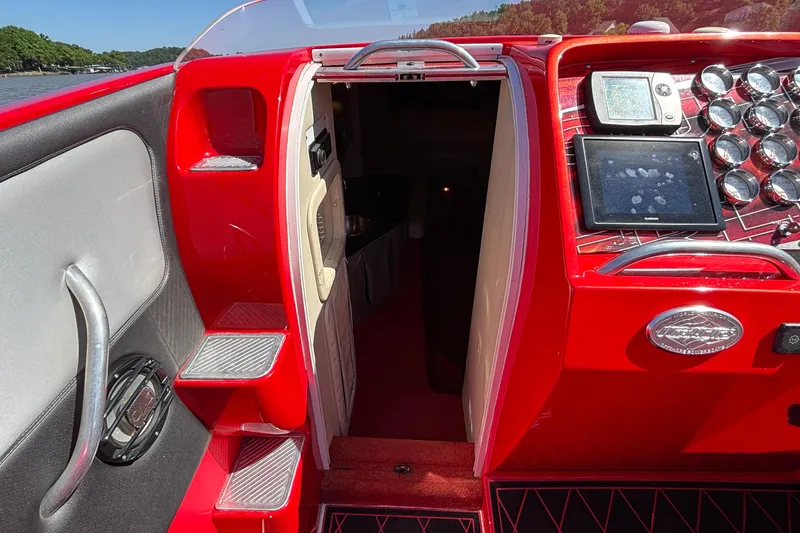 Slide: The Image of Red 2004 Outerlimits 42 Legacy boat interior with control panel and cabin entrance. - 19