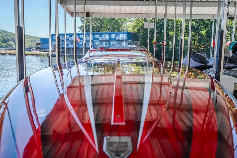 Slide: The Image of 2004 Outerlimits 42 Legacy speedboat docked, reflecting vibrant red and white colors. - 35