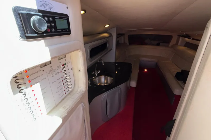 Slide: The Image of Interior of 2004 Outerlimits 42 Legacy boat with control panel and seating area. - 21
