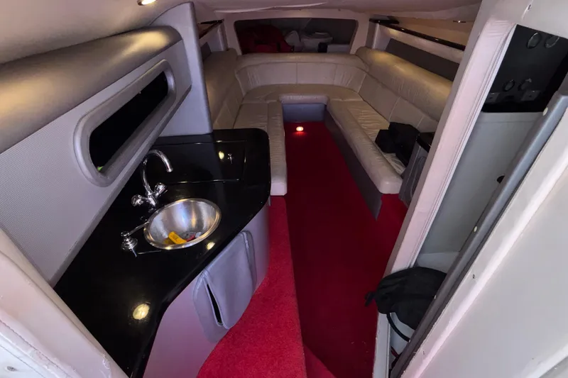 Slide: The Image of Interior of 2004 Outerlimits 42 Legacy boat with red carpet and leather seating. - 22