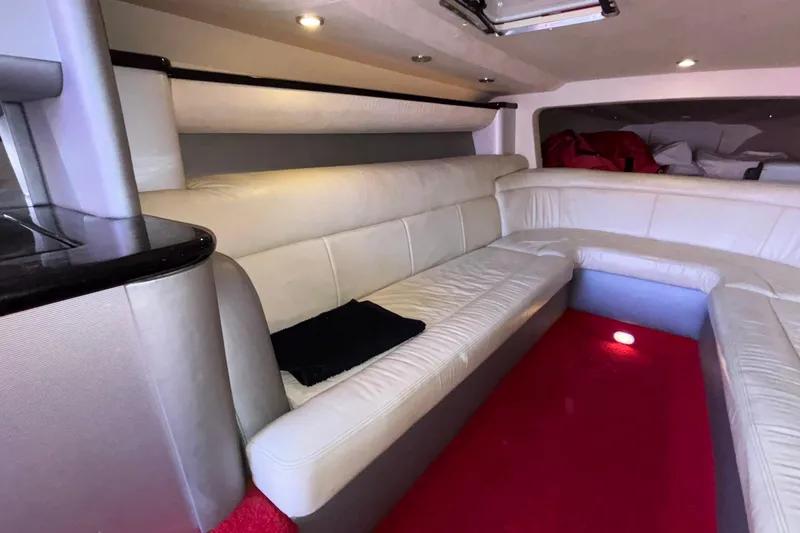 Slide: The Image of Interior of 2004 Outerlimits 42 Legacy boat with white leather seating and red carpet. - 24