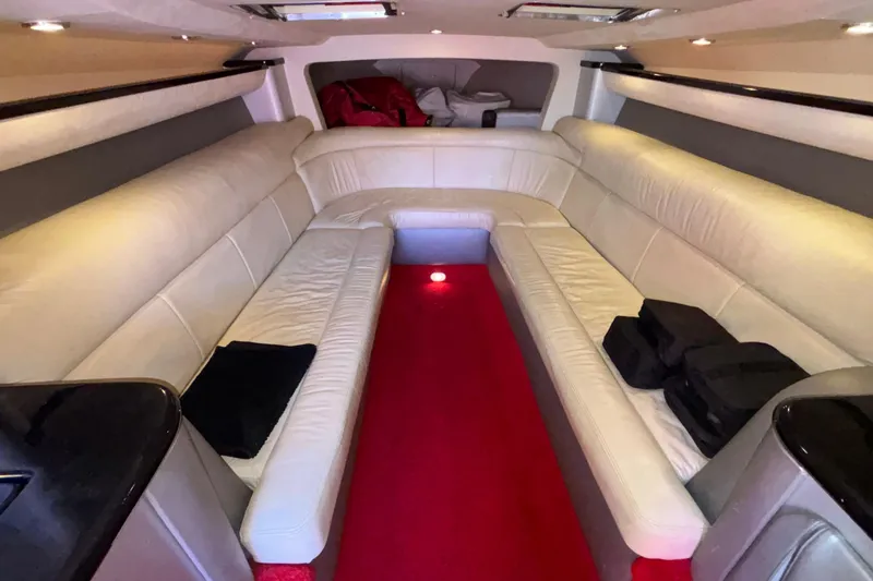 Slide: The Image of Luxurious interior of a 2004 Outerlimits 42 Legacy boat with plush seating and red carpet. - 25