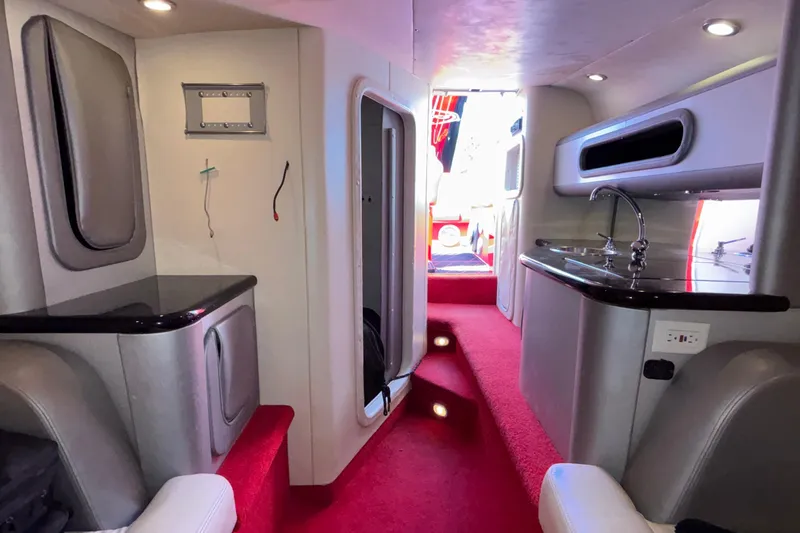 Slide: The Image of Interior of a 2004 Outerlimits 42 Legacy boat with modern amenities and red carpet. - 28