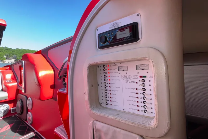 Slide: The Image of 2004 Outerlimits 42 Legacy boat interior with control panel and red seating. - 31