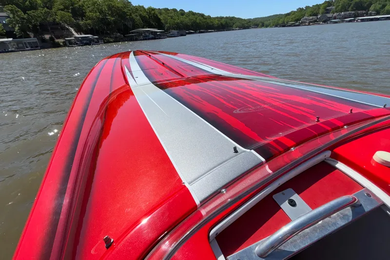 Slide: The Image of 2004 Outerlimits 42 Legacy speedboat with red and silver design on a lake. - 32