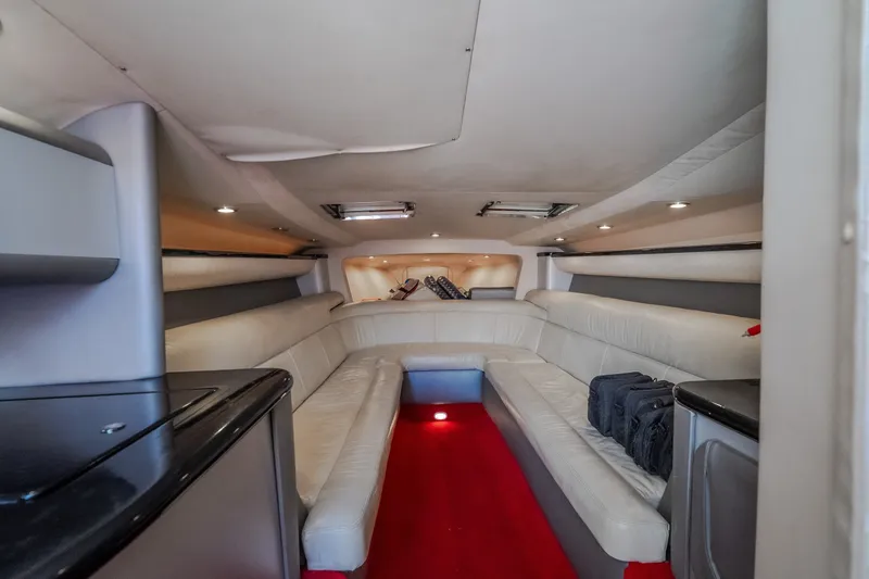 Slide: The Image of Interior of 2004 Outerlimits 42 Legacy boat with luxurious seating and red carpet. - 39