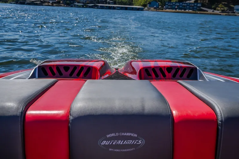 Slide: The Image of 2004 Outerlimits 42 Legacy boat on water, featuring red and black seating. - 15