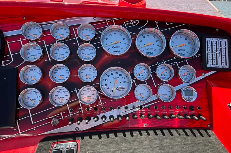 Slide: The Image of Dashboard of a 2004 Outerlimits 42 Legacy boat with multiple gauges and controls. - 38
