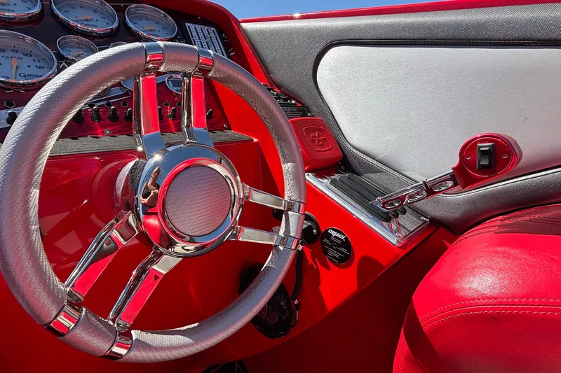 Slide: The Image of Red and chrome steering wheel of 2004 Outerlimits 42 Legacy boat interior. - 39
