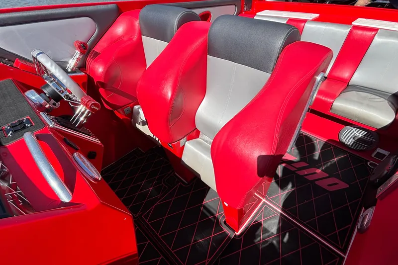 Slide: The Image of Interior of a 2004 Outerlimits 42 Legacy boat with red and gray seating. - 42