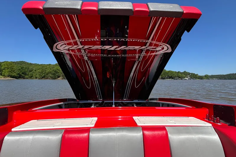 Slide: The Image of 2004 Outerlimits 42 Legacy boat with open engine hatch on a sunny lake. - 47