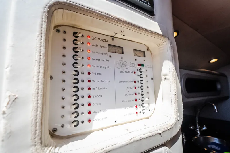Slide: The Image of Control panel inside 2004 Outerlimits 42 Legacy boat, featuring various lighting and power switches. - 37