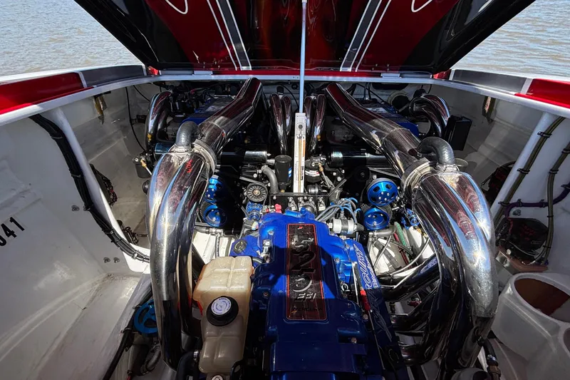 Slide: The Image of Engine compartment of a 2004 Outerlimits 42 Legacy boat with polished components. - 49