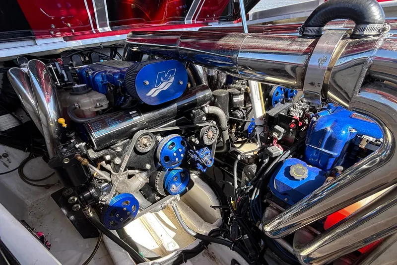 Slide: The Image of Engine compartment of a 2004 Outerlimits 42 Legacy boat, featuring polished components. - 50