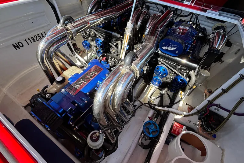 Slide: The Image of 2004 Outerlimits 42 Legacy boat engine compartment with chrome and blue components. - 52